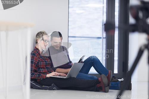 Image of startup business, couple working on laptop computer at office
