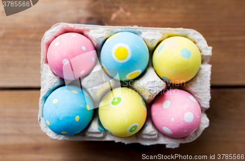 Image of close up of colored easter eggs in egg box