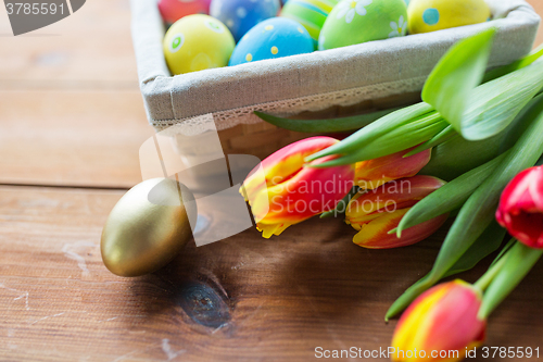 Image of close up of colored easter eggs and flowers