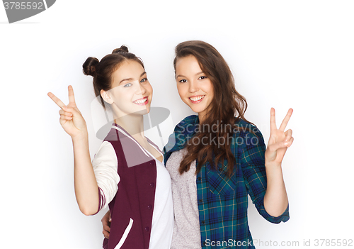 Image of happy teenage girls hugging and showing peace sign