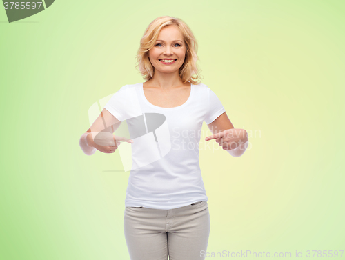 Image of smiling woman in white t-shirt pointing to herself