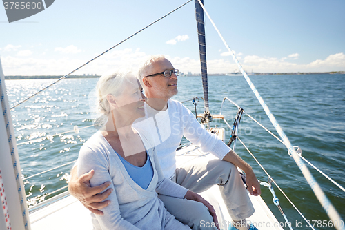 Image of senior couple hugging on sail boat or yacht in sea