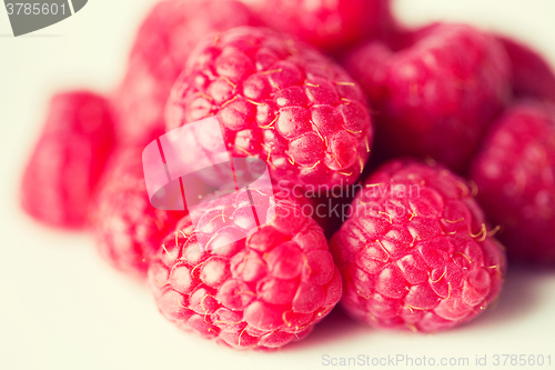 Image of juicy fresh ripe red raspberries on white