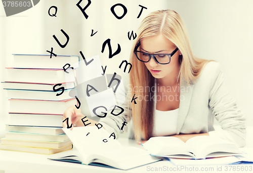 Image of student with books and notes