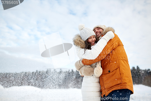 Image of happy couple hugging and laughing in winter