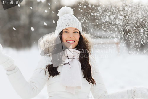 Image of happy woman with snow outdoors in winter