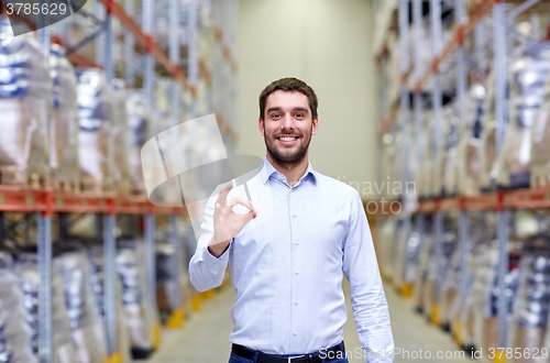 Image of happy man at warehouse showing ok gesture