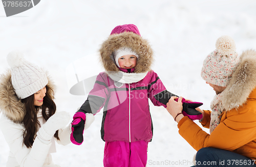 Image of happy family with child in winter clothes outdoors