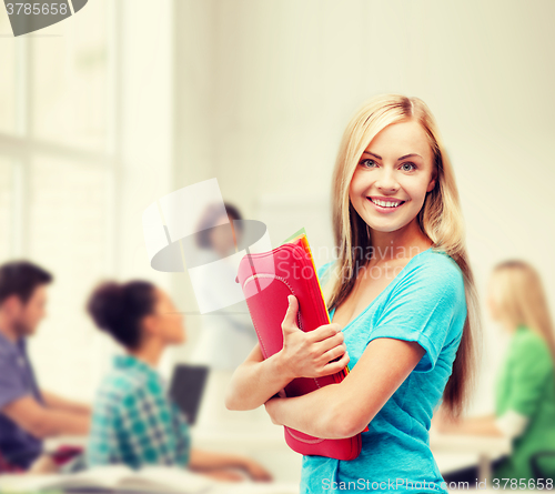 Image of smiling student with folders