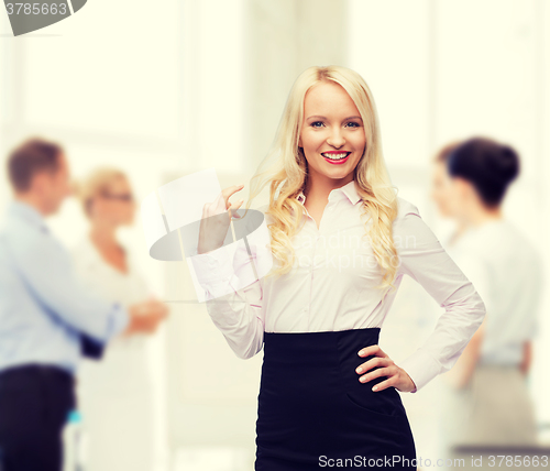 Image of smiling businesswoman or secretary in office
