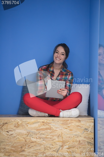 Image of woman in crative box working on tablet