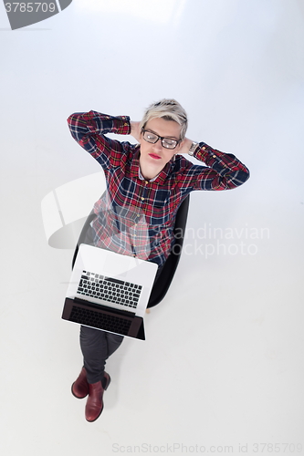 Image of top view of young business woman working on laptop computer