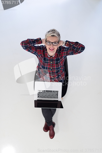 Image of top view of young business woman working on laptop computer