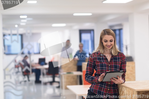 Image of portrait of young business woman at office with team in backgrou