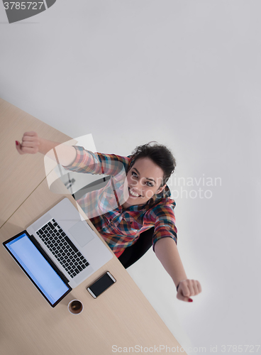 Image of top view of young business woman working on laptop