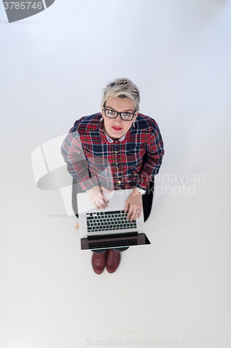 Image of top view of young business woman working on laptop computer