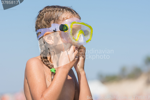 Image of Girl wears swimming underwater mask on the face