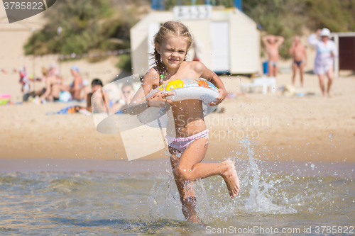 Image of  Girl runs to bathe in the sea