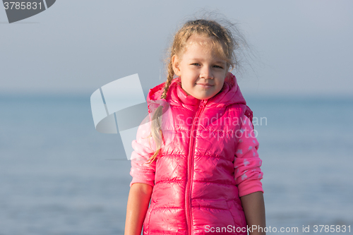 Image of Portrait of the girl in a jacket in the early morning on the beach