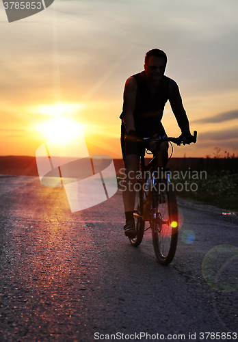 Image of cyclist at sunset time