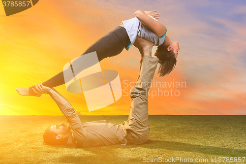 Image of The group of people doing yoga exercises 