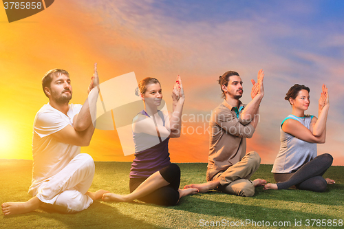 Image of The group of people doing yoga exercises 