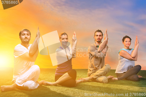 Image of The group of people doing yoga exercises 