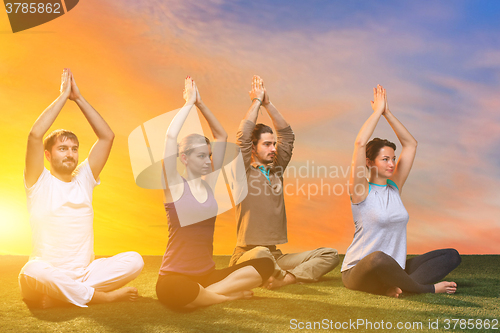 Image of The group of people doing yoga exercises 