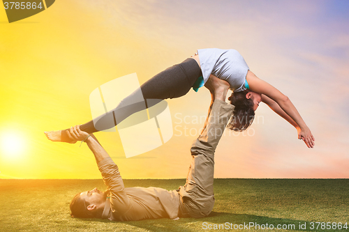 Image of The group of people doing yoga exercises 