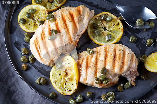 Image of grilled chicken breasts on gray plate