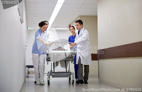 Image of medics and patient on hospital gurney at emergency