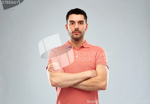 Image of young man with crossed arms over gray background