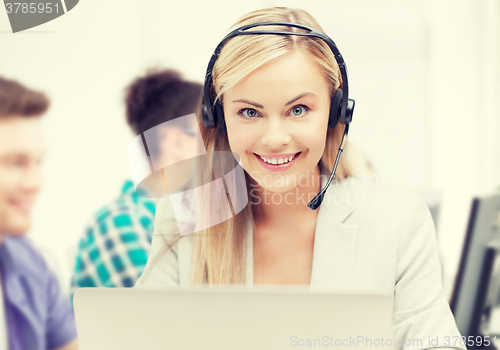 Image of helpline operator with headphones in call centre