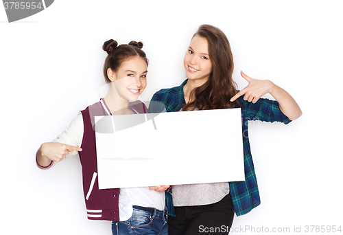 Image of smiling teenage girls holding white blank board