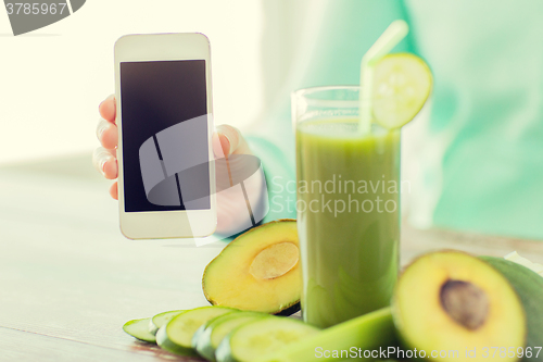 Image of close up of woman with smartphone and vegetables