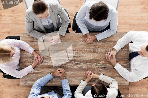 Image of close up of business team sitting at table