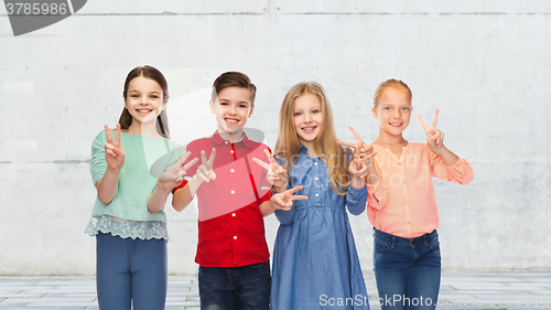 Image of happy boy and girls showing peace hand sign