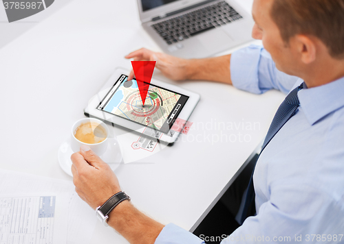 Image of businessman with tablet pc and coffee in office