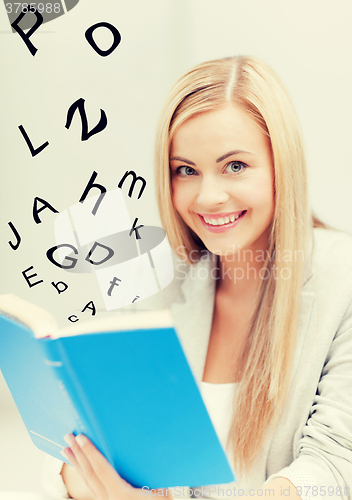 Image of young woman reading book
