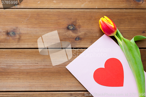 Image of close up of flowers and greeting card with heart