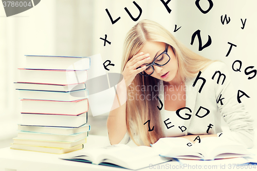 Image of student with books and notes