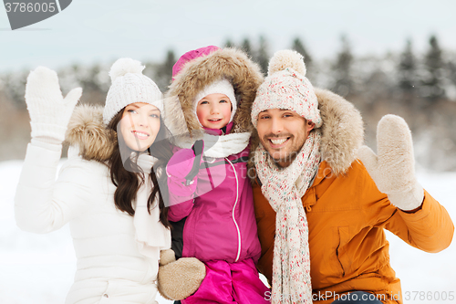 Image of happy family waving hands outdoors in winter