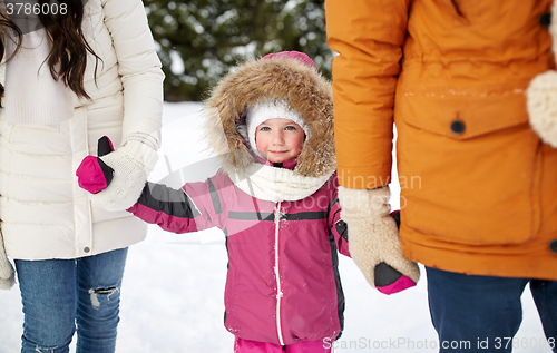 Image of happy family with child in winter clothes outdoors