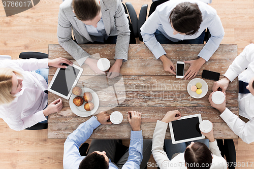 Image of close up of business team drinking coffee on lunch