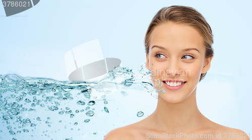 Image of woman face and shoulders over water splash