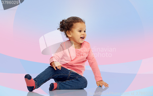 Image of smiling little baby girl sitting on floor