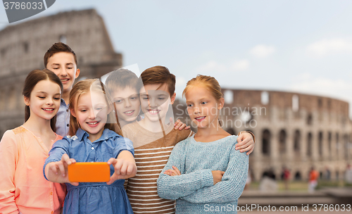 Image of children talking smartphone selfie over coliseum