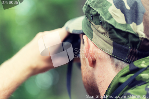 Image of close up of soldier or hunter with binocular