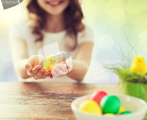 Image of close up of girl holding easter chicken toy