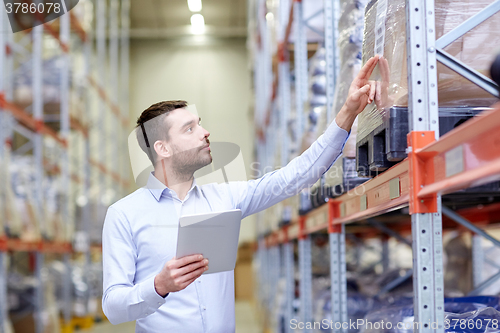 Image of businessman with tablet pc at warehouse